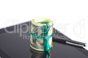 tablet,tube of dollars and stylus isolated on white