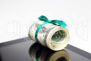 tablet and tube of dollars  isolated on white