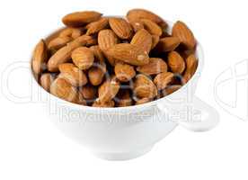 Raw organic almonds in measuring cup