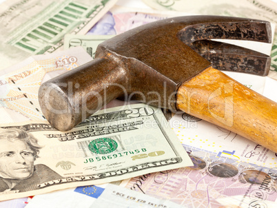 Hammer on top of dollar note