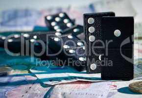 Fallen dominoes on bank notes