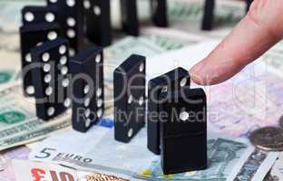 Standing dominoes on bank notes