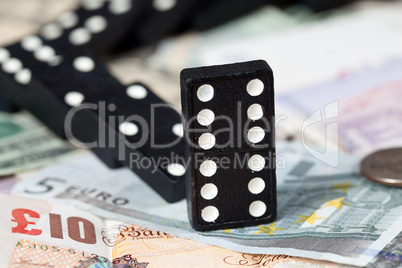 Fallen dominoes on bank notes