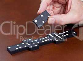 Game of dominoes on leather table