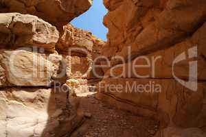 Narrow slot between two rocks in desert canyon