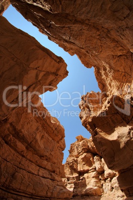 Narrow slot between two rocks in desert canyon