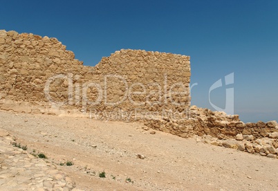 Jagged wall of ancient Masada fortress ruin in the desert near the Dead Sea