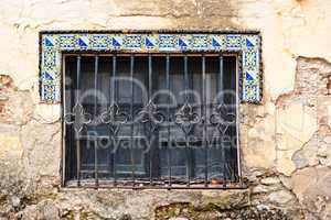 Window of old house in Andalusia with Moorish style tiles