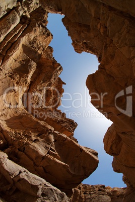 Narrow slot between two rocks in desert canyon