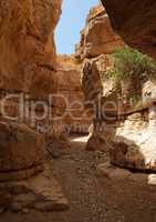 Narrow slot between two rocks in desert canyon