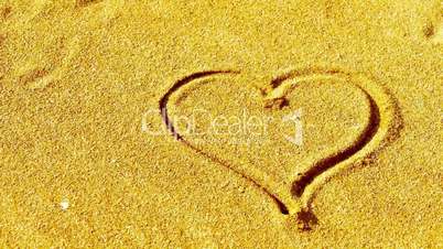 heart on sandy beach,wind blow sand.