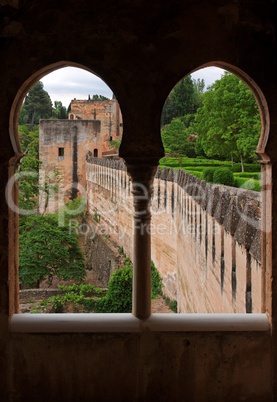 Medieval bastions seen through the castle window in Alhambra, Spain