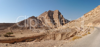 Scenic ridged brown rock at the road  in stone desert