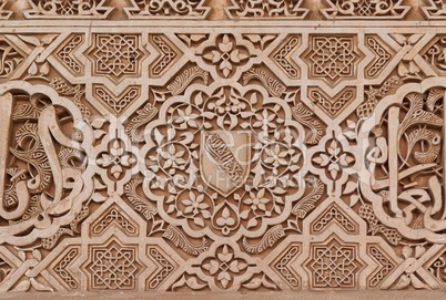 Arabic stone engravings on the Alhambra palace wall in Granada, Spain