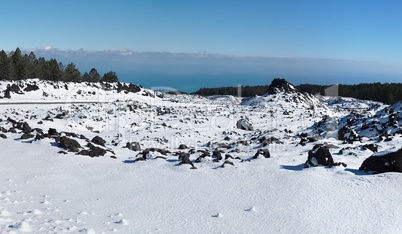 Lava field covered with snow in winter on Etna volcano, Sicily