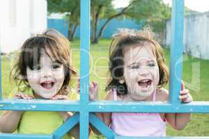 Portrait of happy two sisters outdoors having fun