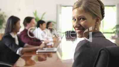 Happy businesswoman smiling at conference in office