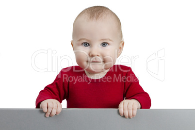 young child holding grey sign