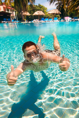 teenager floats in pool