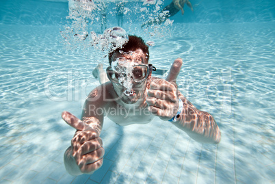 man floats in pool