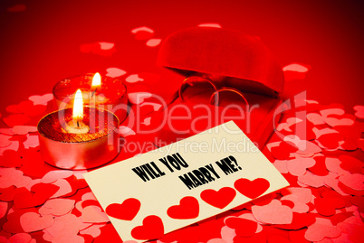 Card with marriage proposal and two rings and two candles