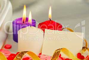 Three burning candles over light background