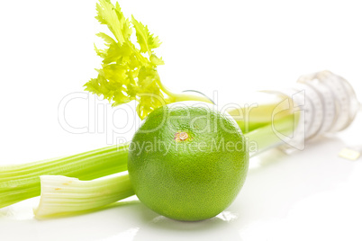 celery in a tall glass, green grapefruit and measure tape isolat