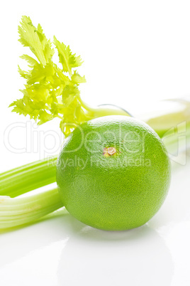 celery in a tall glass, green grapefruit and measure tape isolat