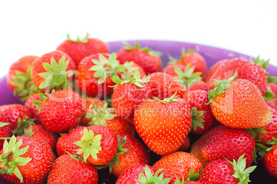 strawberries in a glass plate isolated on white