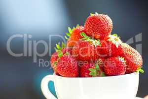 strawberries in a bowl in the daylight