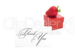 red gift box, thank you card and strawberries isolated on white