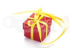 red gift box with a yellow ribbon isolated on white