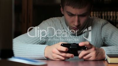 young man playing on console. slider shot.
