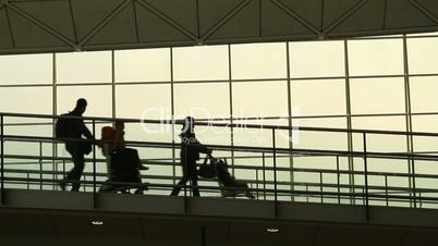 Silhouettes of Family Travellers in Airport