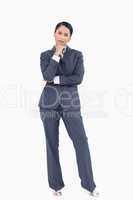 Standing businesswoman in thoughts