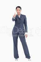 Standing businesswoman giving thumb up