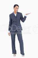 Smiling businesswoman presenting with her palm up