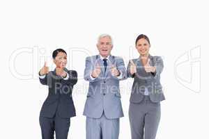 Three businesspeople giving thumbs up