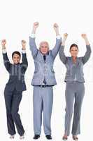 Three businesspeople with arms up