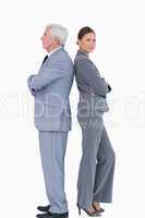 Mature businessman back to back with colleague