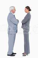 Businesspartner standing face to face with arms folded