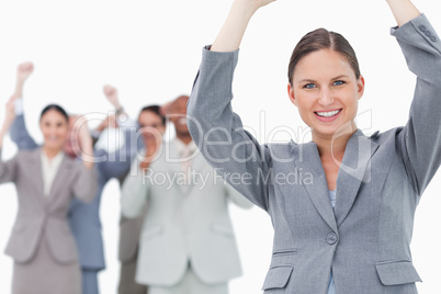 Cheering tradeswoman with team behind her