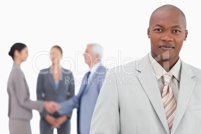 Businessman with trading partners behind him