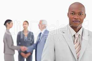 Businessman with trading partners behind him