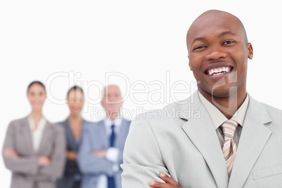 Smiling salesman with team behind him