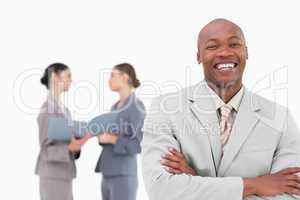 Laughing tradesman with colleagues behind him