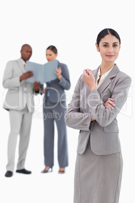 Saleswoman with co-workers behind her