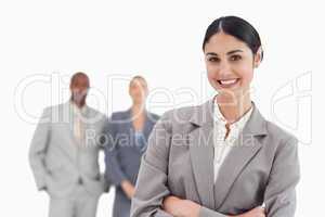 Smiling tradeswoman with co-workers behind her