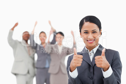 Saleswoman with cheering team behind her giving approval