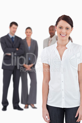 Smiling businesswoman with three co-workers behind her